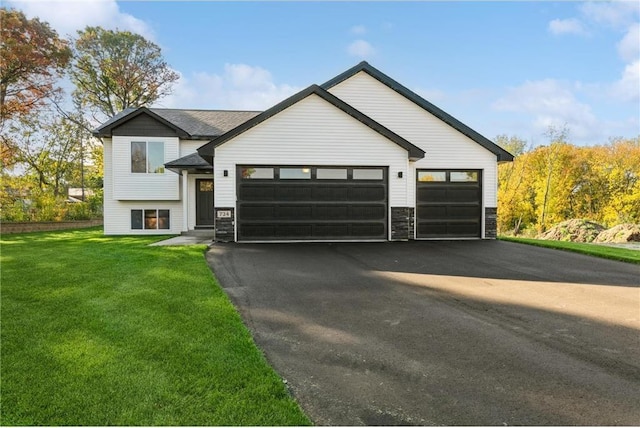 6006 Fuller Cir, Wyoming, MN 55092 - view of front facade featuring an attached garage, asphalt driveway, a front yard, and stone siding