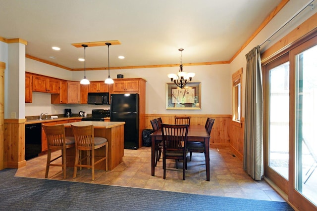 24909 Sandy Ln, Bay Lake Twp, MN 56444 - kitchen featuring plenty of natural light, black appliances, a kitchen island, a chandelier, and wainscoting