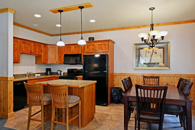 24909 Sandy Ln, Bay Lake Twp, MN 56444 - kitchen with black appliances, a wainscoted wall, a chandelier, wooden walls, and a kitchen island