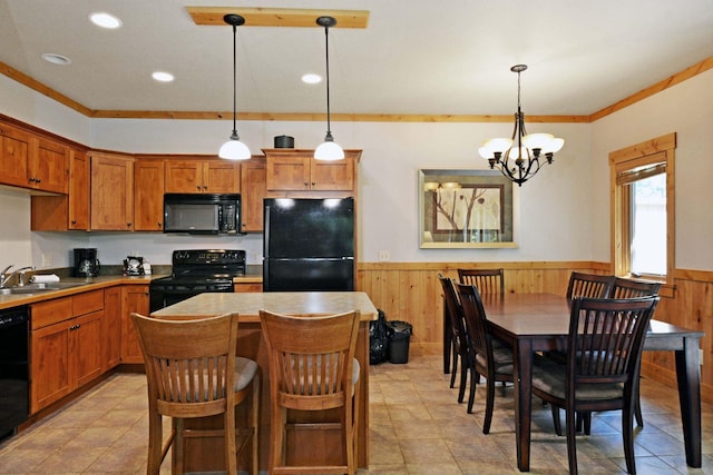 24909 Sandy Ln, Bay Lake Twp, MN 56444 - kitchen with a wainscoted wall, black appliances, a chandelier, wood walls, and a kitchen island
