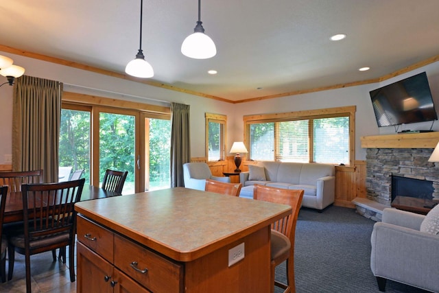 24909 Sandy Ln, Bay Lake Twp, MN 56444 - kitchen with open floor plan, healthy amount of natural light, a wainscoted wall, a fireplace, and brown cabinets