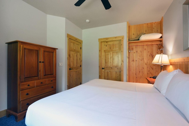 24909 Sandy Ln, Bay Lake Twp, MN 56444 - bedroom with a ceiling fan and wooden walls