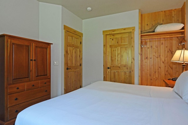 24909 Sandy Ln, Bay Lake Twp, MN 56444 - bedroom featuring wood walls