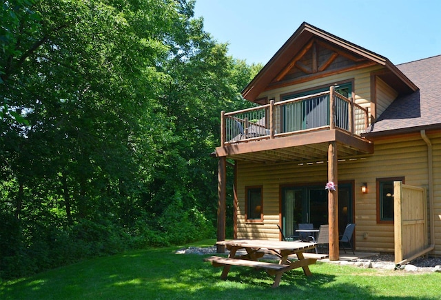 24909 Sandy Ln, Bay Lake Twp, MN 56444 - back of house with a shingled roof and a yard
