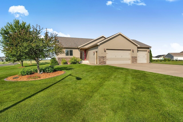 511 8th St SW, Rice, MN 56367 - view of front facade featuring a garage, concrete driveway, a front yard, and stone siding