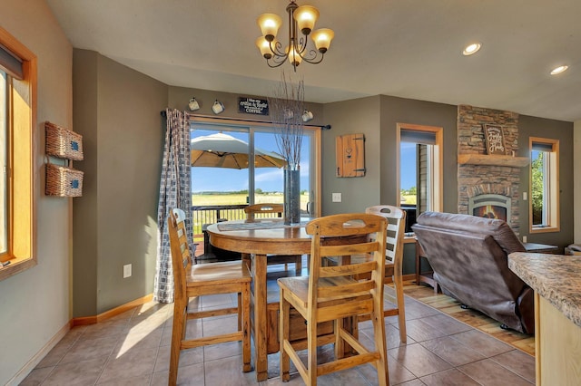 511 8th St SW, Rice, MN 56367 - dining area with a chandelier, a stone fireplace, light tile patterned floors, and recessed lighting