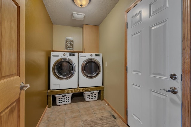 511 8th St SW, Rice, MN 56367 - washroom featuring separate washer and dryer, light tile patterned floors, a textured ceiling, and cabinet space