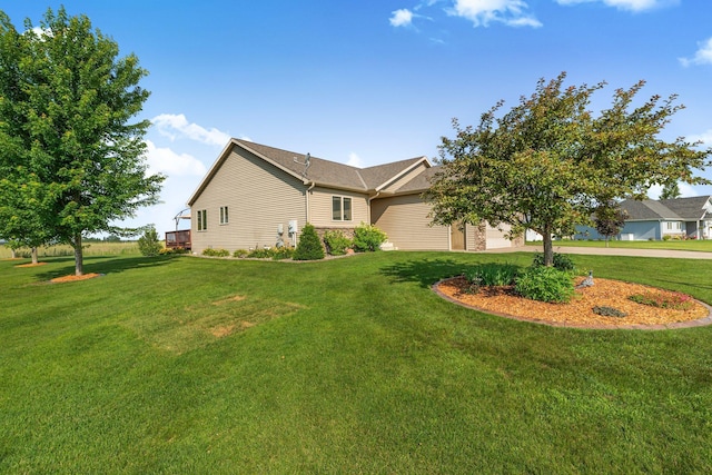 511 8th St SW, Rice, MN 56367 - view of side of property with a yard, concrete driveway, and a garage