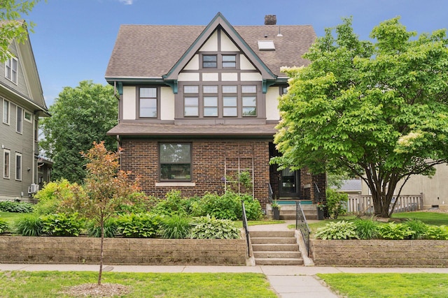 1088 Lincoln Ave, Saint Paul, MN 55105 - tudor-style house with a shingled roof, stucco siding, and brick siding