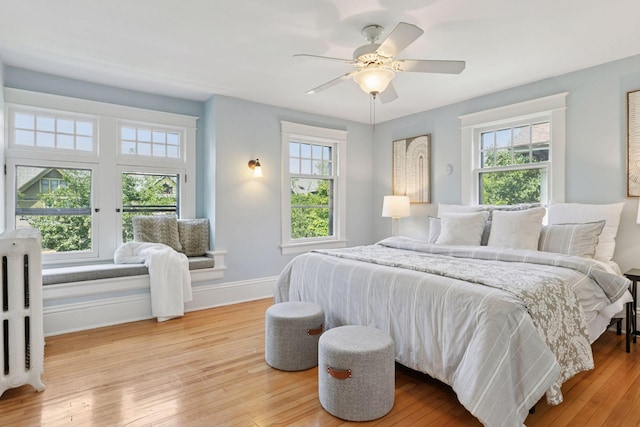 1088 Lincoln Ave, Saint Paul, MN 55105 - bedroom featuring multiple windows, wood finished floors, radiator, and a ceiling fan