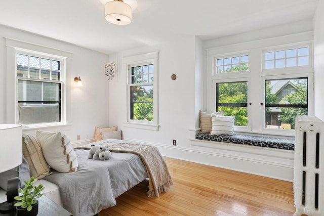 1088 Lincoln Ave, Saint Paul, MN 55105 - bedroom with multiple windows, hardwood / wood-style flooring, and radiator heating unit