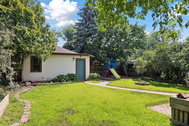 1088 Lincoln Ave, Saint Paul, MN 55105 - fenced backyard with an outdoor fire pit and a playground