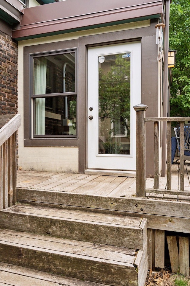 1088 Lincoln Ave, Saint Paul, MN 55105 - doorway to property with a wooden deck and brick siding