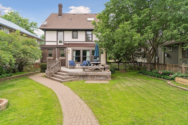 1088 Lincoln Ave, Saint Paul, MN 55105 - rear view of property with stucco siding, a fenced backyard, a chimney, a deck, and a shingled roof