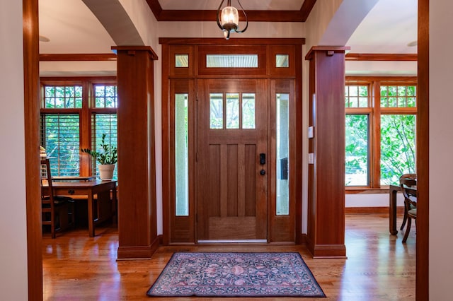 582 Summit Ave, Saint Paul, MN 55102 - foyer entrance featuring arched walkways, wood finished floors, healthy amount of natural light, and ornamental molding
