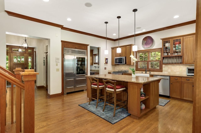582 Summit Ave, Saint Paul, MN 55102 - kitchen featuring stainless steel appliances, open shelves, light wood-type flooring, a center island, and recessed lighting