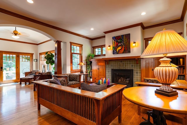 582 Summit Ave, Saint Paul, MN 55102 - living room featuring a ceiling fan, a tile fireplace, wood finished floors, arched walkways, and recessed lighting