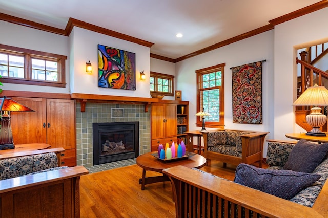 582 Summit Ave, Saint Paul, MN 55102 - living room with ornamental molding, wood finished floors, a tiled fireplace, and recessed lighting