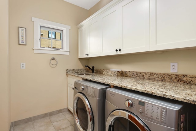 582 Summit Ave, Saint Paul, MN 55102 - washroom featuring separate washer and dryer, cabinet space, and light tile patterned flooring
