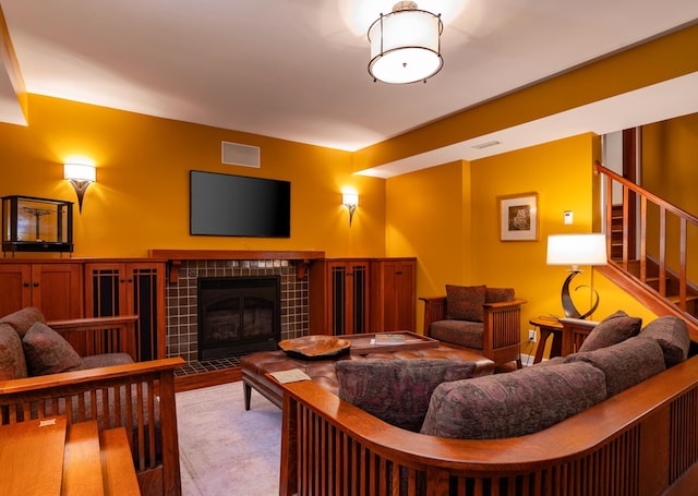 582 Summit Ave, Saint Paul, MN 55102 - living room featuring a tiled fireplace and stairs