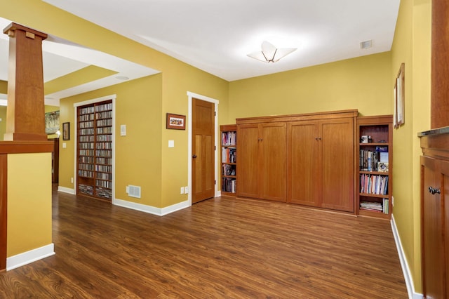 582 Summit Ave, Saint Paul, MN 55102 - empty room featuring dark wood-style flooring and decorative columns