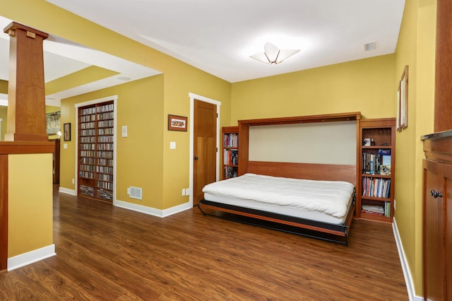 582 Summit Ave, Saint Paul, MN 55102 - bedroom with wood finished floors and ornate columns