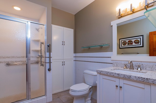 582 Summit Ave, Saint Paul, MN 55102 - bathroom featuring vanity, a stall shower, tile patterned floors, and tile walls