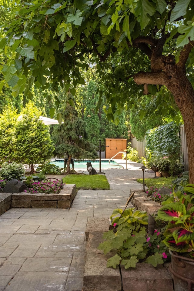 582 Summit Ave, Saint Paul, MN 55102 - fenced backyard featuring a patio and a storage shed