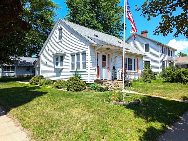 521 Chestnut St, Winona, MN 55987 - view of front facade featuring a front lawn, roof with shingles, and a chimney