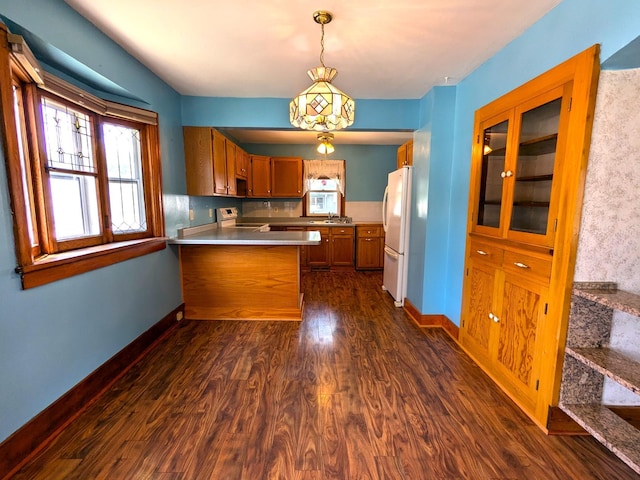 521 Chestnut St, Winona, MN 55987 - kitchen featuring freestanding refrigerator, electric range oven, a peninsula, dark wood finished floors, and brown cabinetry