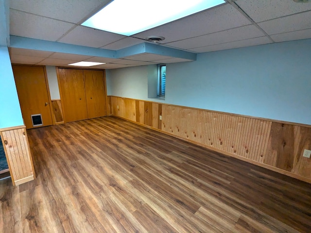 521 Chestnut St, Winona, MN 55987 - finished basement with a drop ceiling, wood finished floors, a wainscoted wall, and wooden walls