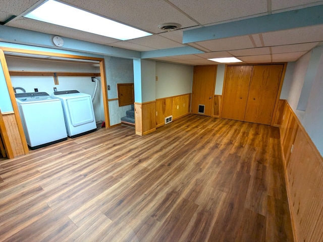 521 Chestnut St, Winona, MN 55987 - finished basement featuring a drop ceiling, a wainscoted wall, wood finished floors, wood walls, and independent washer and dryer