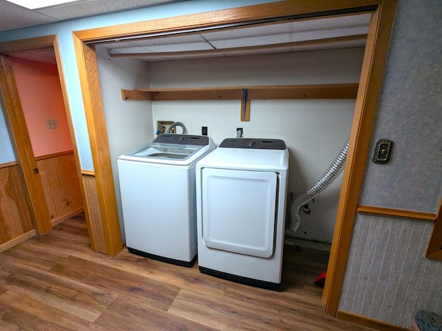 521 Chestnut St, Winona, MN 55987 - laundry area with washer and dryer, wood finished floors, a wainscoted wall, and wood walls