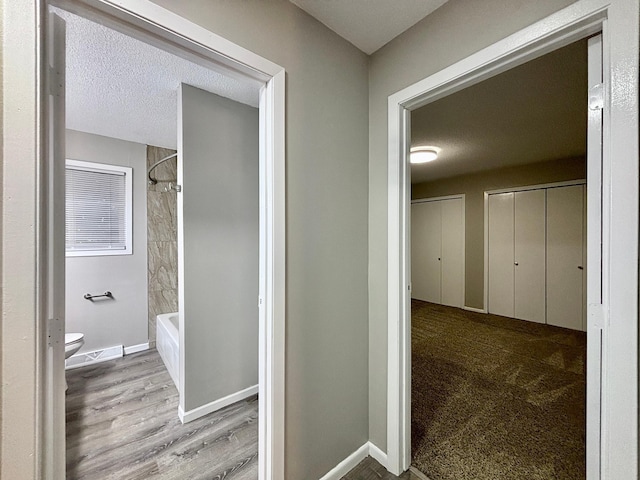 1414 Danube Rd, Fridley, MN 55432 - hallway featuring wood finished floors and a textured ceiling