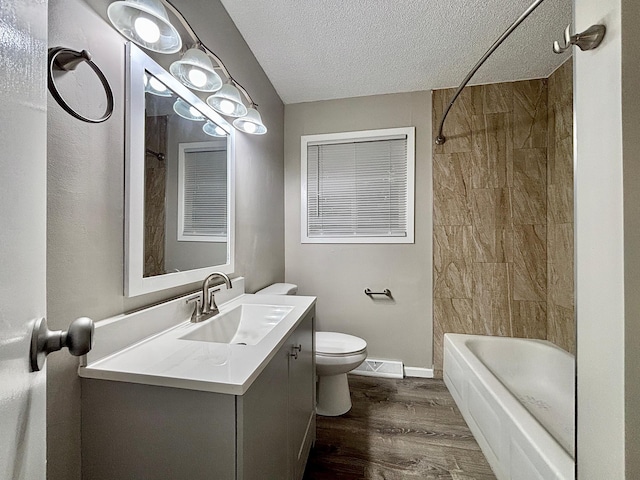 1414 Danube Rd, Fridley, MN 55432 - full bath with wood finished floors, vanity, a textured ceiling, and washtub / shower combination