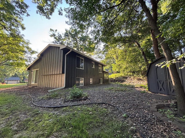 1414 Danube Rd, Fridley, MN 55432 - view of home's exterior with board and batten siding and a storage unit