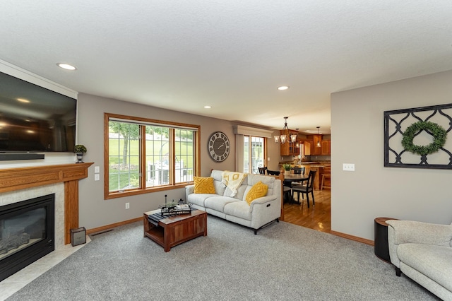 2944 Mayowood Common Cir SW, Rochester, MN 55902 - living area with carpet floors, a premium fireplace, recessed lighting, and a chandelier