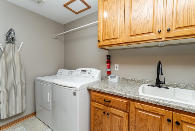 2944 Mayowood Common Cir SW, Rochester, MN 55902 - laundry room featuring washing machine and clothes dryer, cabinet space, and light tile patterned floors
