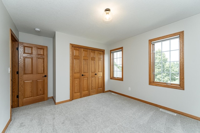 2944 Mayowood Common Cir SW, Rochester, MN 55902 - unfurnished bedroom with a closet and carpet