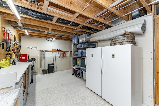 2944 Mayowood Common Cir SW, Rochester, MN 55902 - unfinished below grade area with freestanding refrigerator and a workshop area