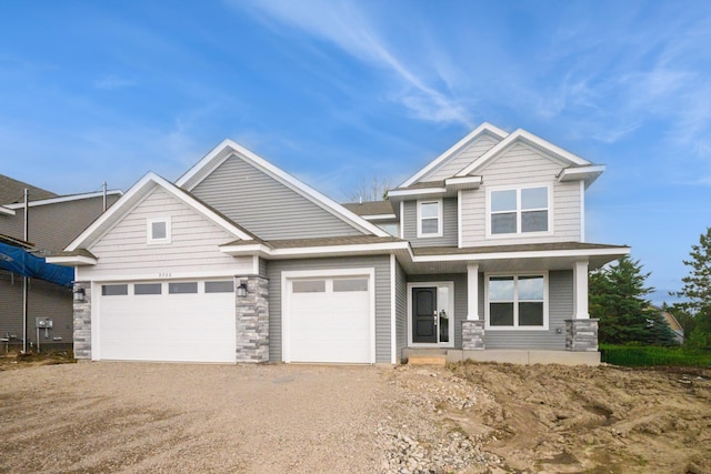 9706 Jasmine Ave NE, Hanover, MN 55341 - craftsman-style home featuring an attached garage, driveway, stone siding, and a porch