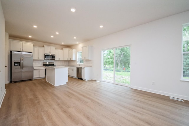 9706 Jasmine Ave NE, Hanover, MN 55341 - kitchen with stainless steel appliances, backsplash, open floor plan, light wood finished floors, and recessed lighting