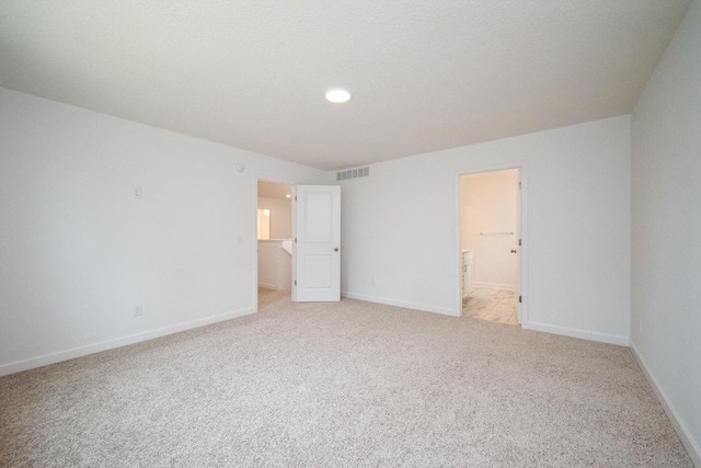 9706 Jasmine Ave NE, Hanover, MN 55341 - unfurnished bedroom with light carpet, ensuite bathroom, and recessed lighting