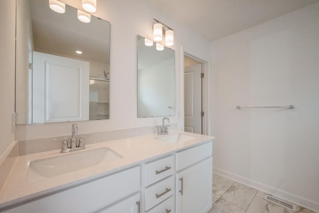 9706 Jasmine Ave NE, Hanover, MN 55341 - bathroom with double vanity, marble finish floors, and a shower with door