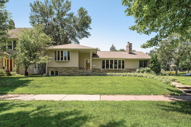 1281 Minnehaha Pkwy, Minneapolis, MN 55419 - split level home with a chimney, a front yard, and stone siding