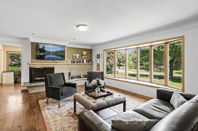 1281 Minnehaha Pkwy, Minneapolis, MN 55419 - living area with a textured ceiling, a fireplace with raised hearth, and wood finished floors