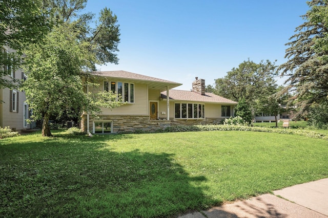 1281 Minnehaha Pkwy, Minneapolis, MN 55419 - view of front facade with a chimney, a front lawn, and stone siding