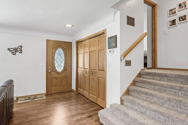 1281 Minnehaha Pkwy, Minneapolis, MN 55419 - entryway featuring wood finished floors, a textured ceiling, and stairway