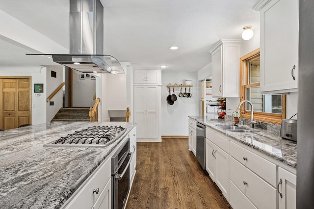 1281 Minnehaha Pkwy, Minneapolis, MN 55419 - kitchen with island exhaust hood, appliances with stainless steel finishes, white cabinetry, dark wood-style flooring, and light stone countertops