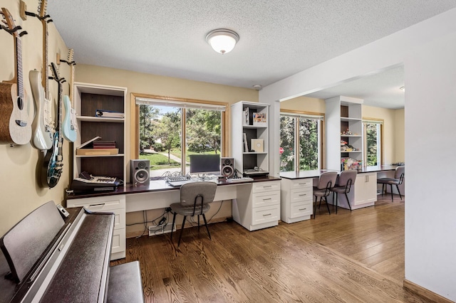 1281 Minnehaha Pkwy, Minneapolis, MN 55419 - office area featuring wood finished floors, built in desk, and a textured ceiling